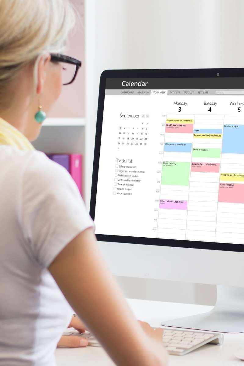 Woman reviewing her website maintenance schedule on her computer calendar.